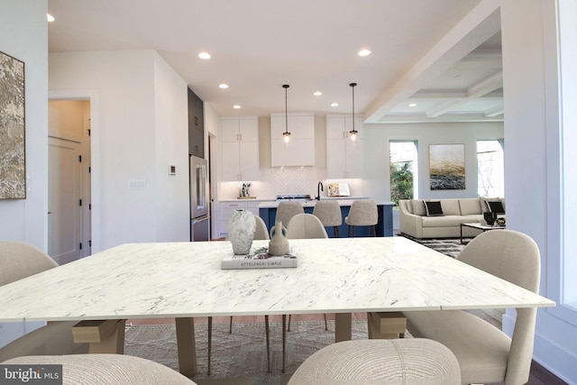 dining room featuring beamed ceiling