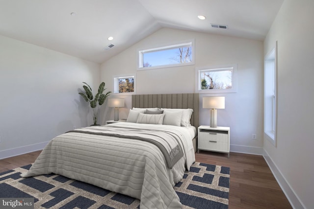 bedroom featuring dark hardwood / wood-style flooring and lofted ceiling