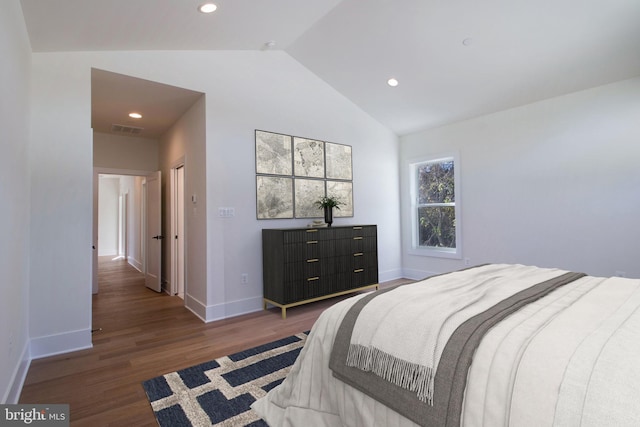 bedroom with vaulted ceiling and dark wood-type flooring