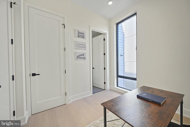 office with light wood-type flooring