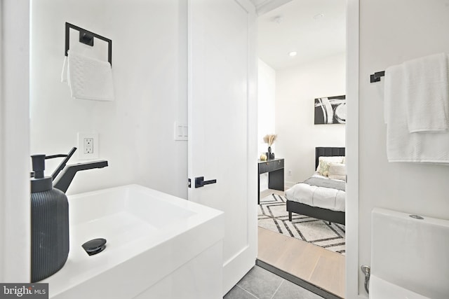 bathroom with hardwood / wood-style flooring and sink