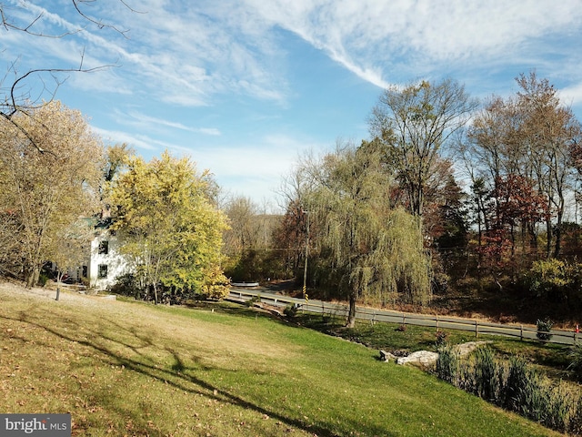 view of property's community featuring a rural view and a lawn