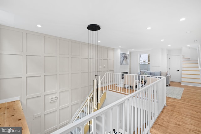 hallway with light hardwood / wood-style floors