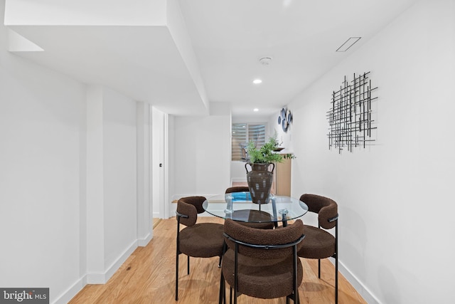 dining space with light hardwood / wood-style flooring