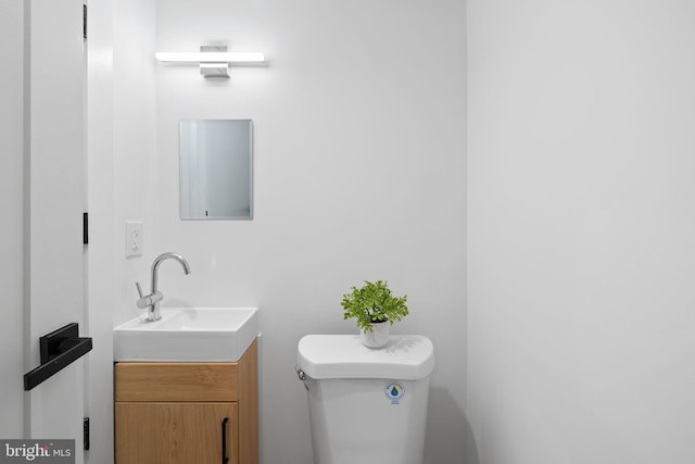 bathroom with toilet and vanity