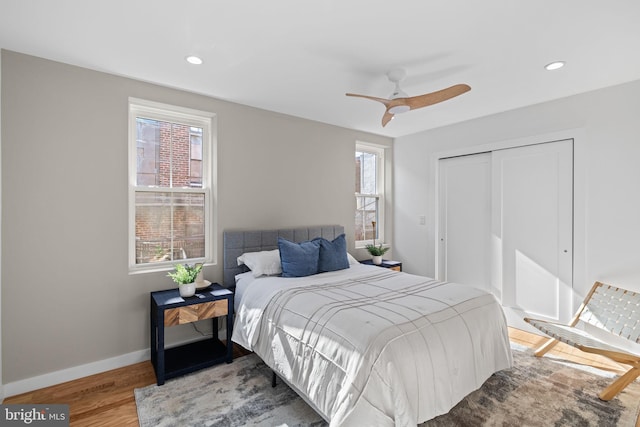 bedroom featuring a closet, wood-type flooring, and ceiling fan