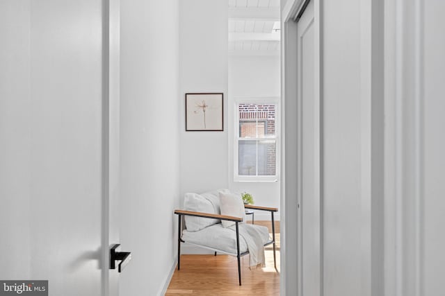 hall featuring wood ceiling, hardwood / wood-style flooring, and beam ceiling