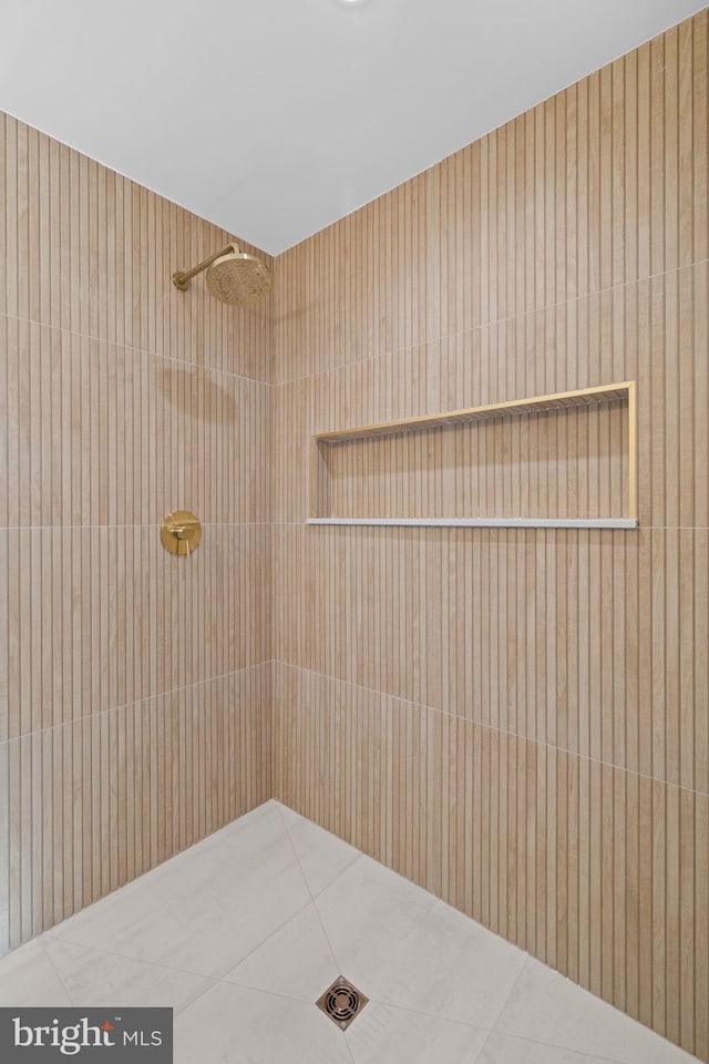 bathroom with a shower and tile patterned floors