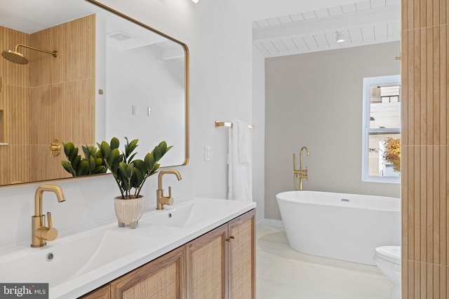 bathroom featuring vanity, beam ceiling, tile patterned flooring, a bathing tub, and toilet