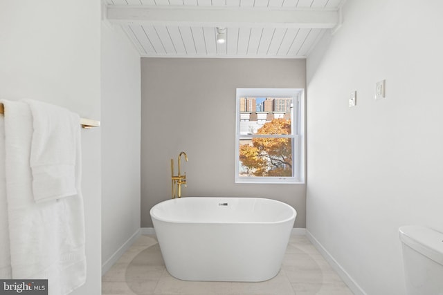 bathroom featuring a tub to relax in, tile patterned flooring, wooden ceiling, and beamed ceiling