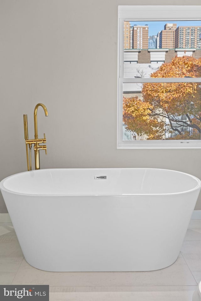 bathroom featuring a bath and tile patterned flooring