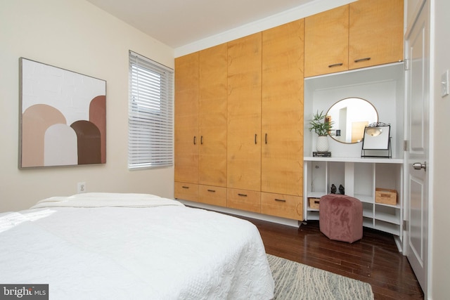 bedroom with dark wood-type flooring