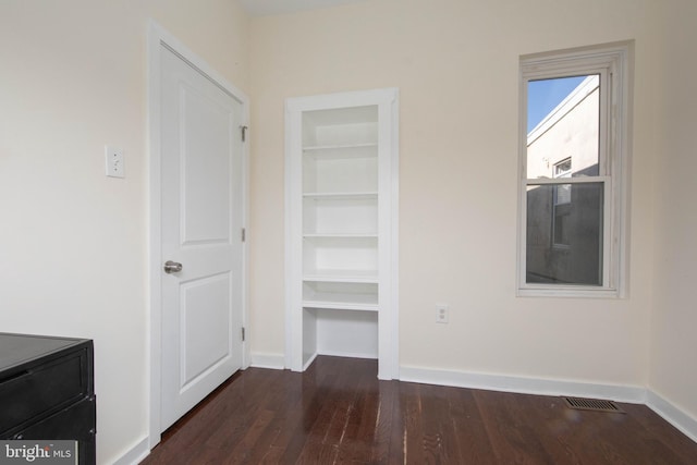 unfurnished bedroom featuring dark wood-type flooring