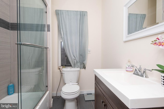 full bathroom featuring shower / bath combination with glass door, vanity, toilet, and tile patterned flooring