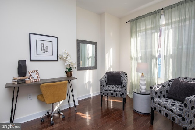 home office with dark hardwood / wood-style floors