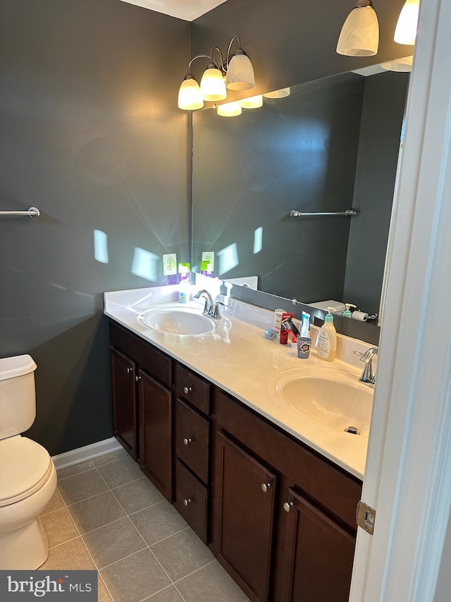 bathroom featuring tile patterned flooring, vanity, and toilet