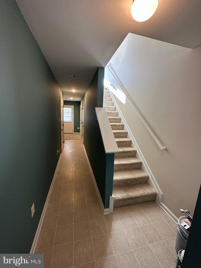 hallway with tile patterned floors