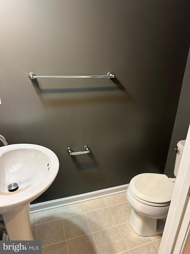 bathroom with tile patterned floors and toilet