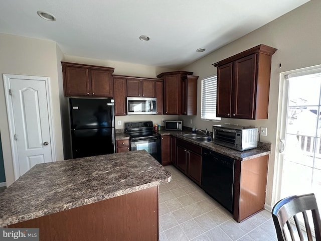 kitchen with black appliances, a center island, light tile patterned flooring, and sink