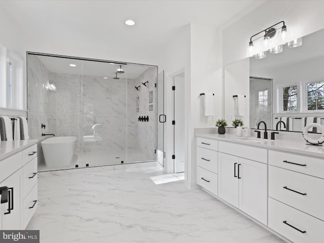 bathroom with vanity and separate shower and tub