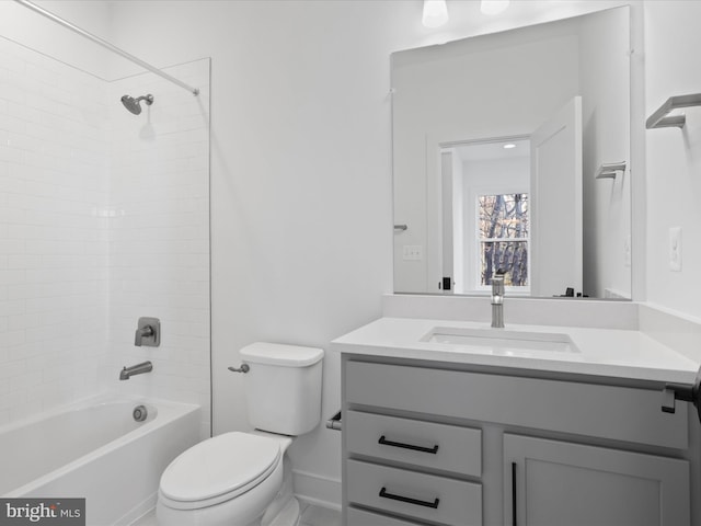 full bathroom with vanity, tiled shower / bath combo, and toilet