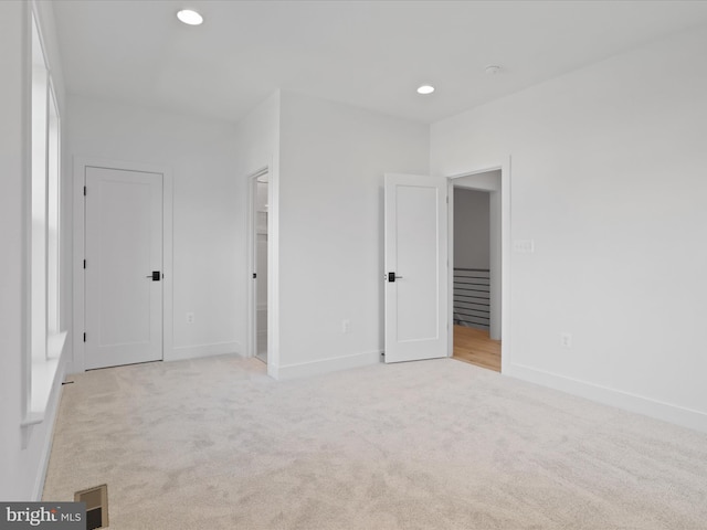 spare room featuring light colored carpet