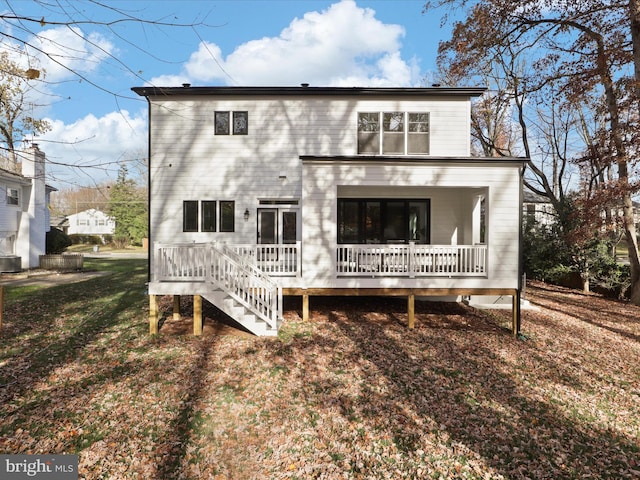 rear view of house featuring a yard and central AC unit