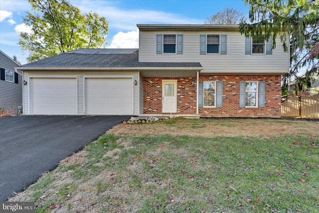 front of property featuring a front yard and a garage