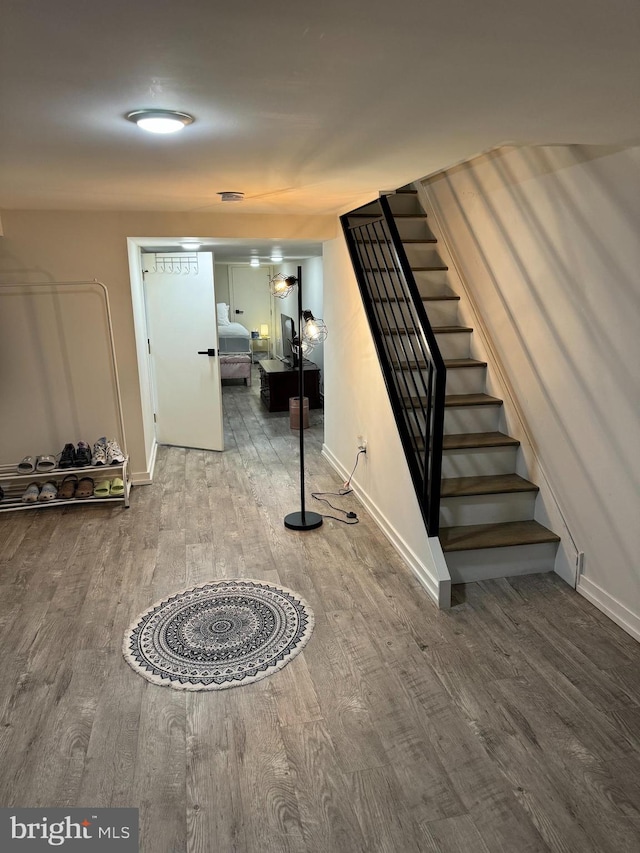 stairs featuring hardwood / wood-style flooring