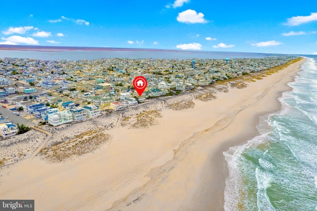 birds eye view of property featuring a water view and a view of the beach