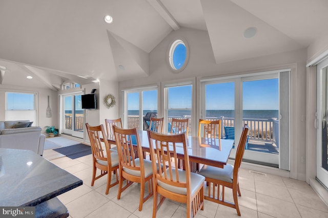 dining space featuring vaulted ceiling with beams and light tile patterned floors