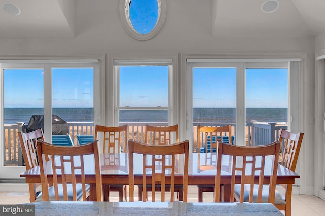 interior space featuring plenty of natural light, a water view, and light tile patterned floors