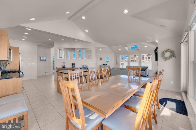 tiled dining area with lofted ceiling with beams