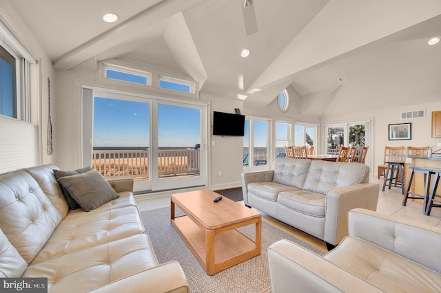 living room featuring ceiling fan and lofted ceiling