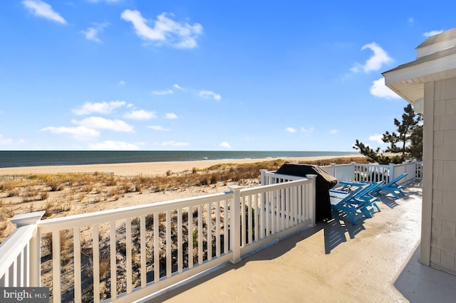 balcony with a beach view and a water view