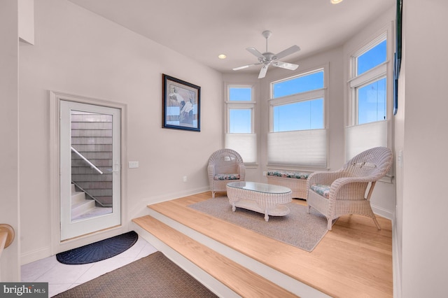 sitting room featuring ceiling fan and light tile patterned floors