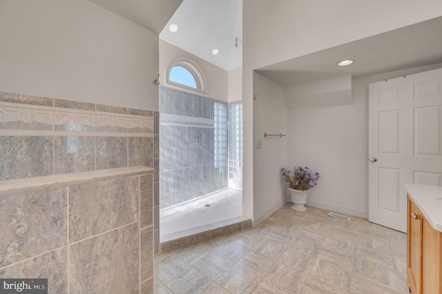 bathroom featuring a shower and vanity