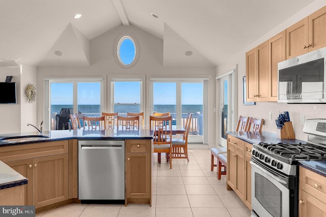 2 N 2nd St, Surf City, NJ 08008 - kitchen with stainless steel appliances, a sink, light tile patterned flooring, dark countertops, and high vaulted ceiling