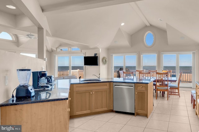 kitchen with ceiling fan, sink, stainless steel dishwasher, dark stone countertops, and light tile patterned floors