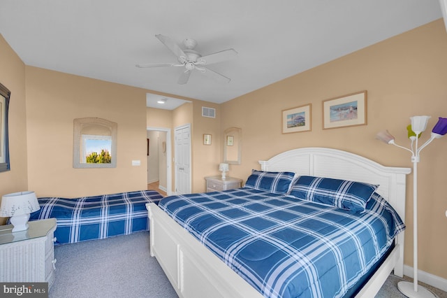 carpeted bedroom with ceiling fan and a closet