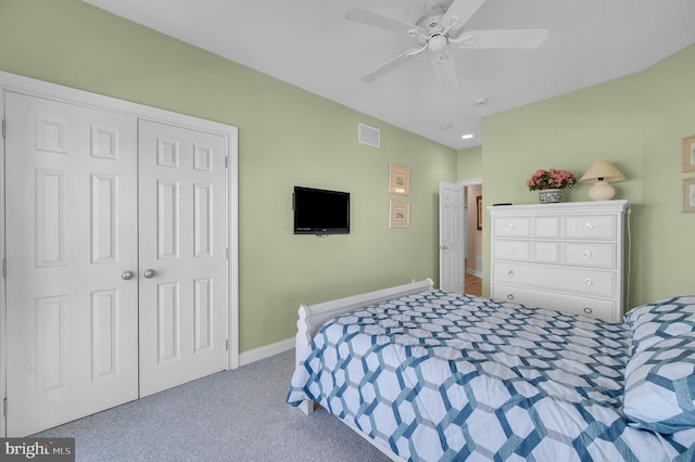 carpeted bedroom featuring a closet and ceiling fan