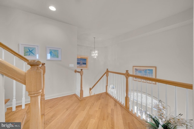 interior space with wood-type flooring and a chandelier