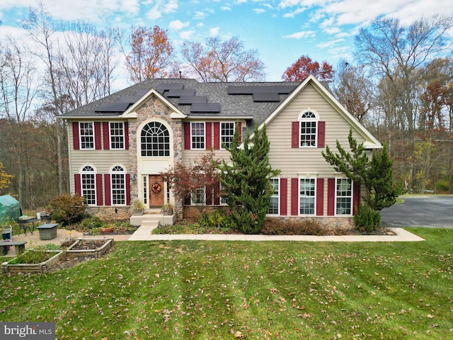 colonial home with a front yard