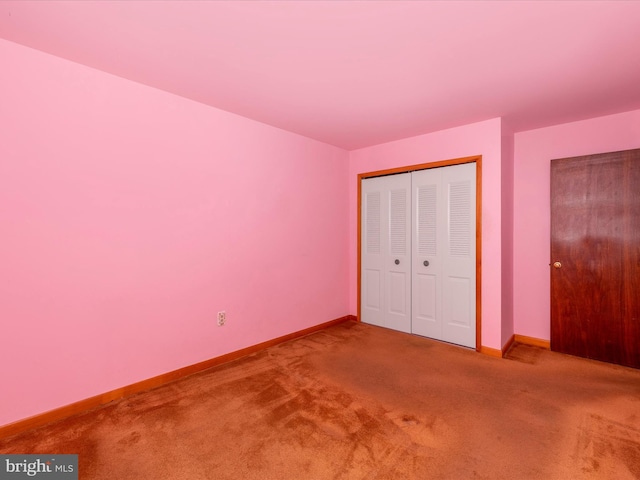 unfurnished bedroom featuring a closet and carpet