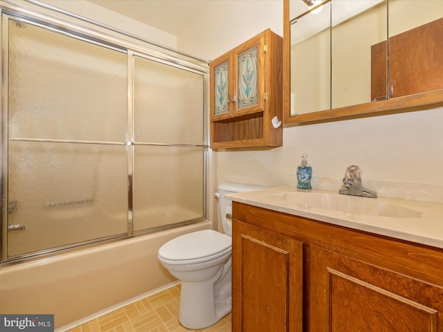 full bathroom featuring toilet, vanity, and combined bath / shower with glass door