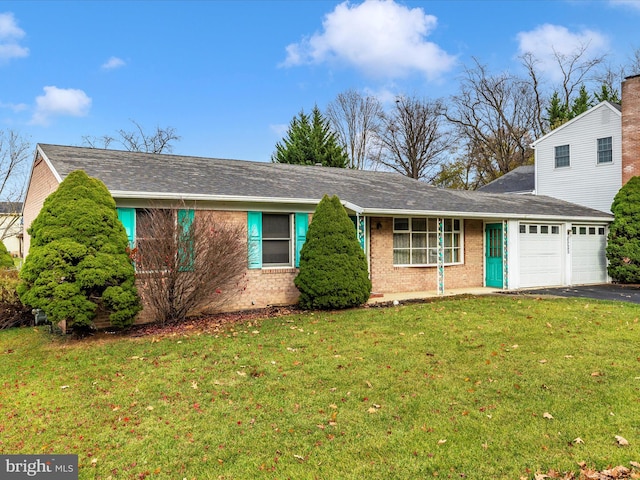 view of front of home with a garage and a front lawn