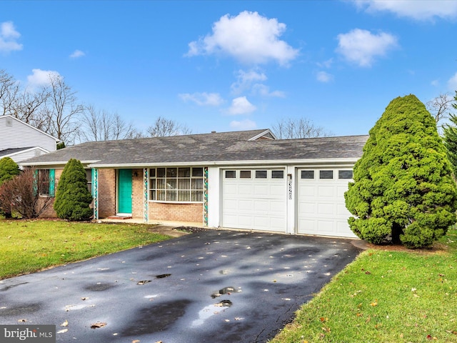 single story home with a garage and a front lawn