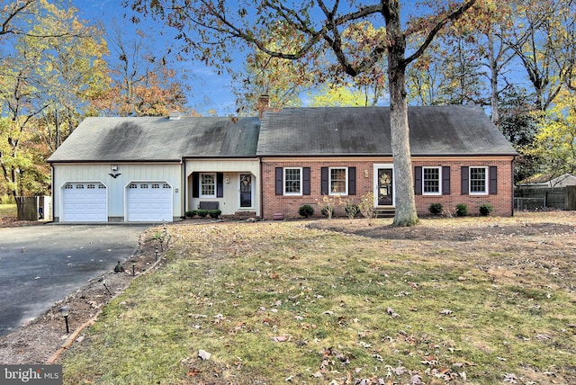 view of front of home featuring a garage and a front lawn