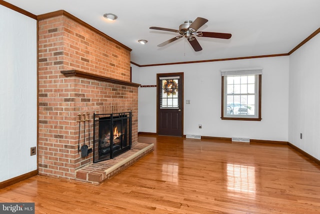 unfurnished living room with a brick fireplace, ceiling fan, ornamental molding, and light wood-type flooring