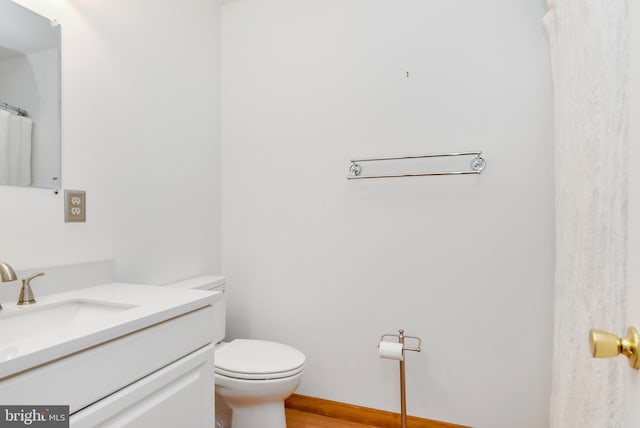 bathroom featuring hardwood / wood-style floors, vanity, and toilet